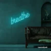 Breathe neon sign in mint green for meditation rooms, yoga studios, and calming home decor.