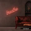 Breathe neon sign in peachy pink for meditation rooms, yoga studios, and calming home decor.