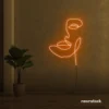 Abstract face neon sign in orange for beauty salons, nail studios, and spa wall decor.