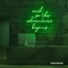 And So The Adventure Begins neon sign in deep green for wedding decor, new beginnings, and celebration walls.