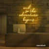 And So The Adventure Begins neon sign in golden yellow for wedding decor, new beginnings, and celebration walls.
