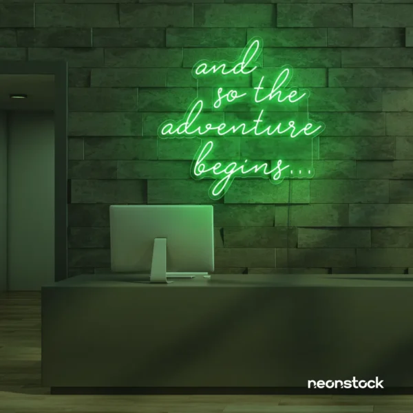 And So The Adventure Begins neon sign in green for wedding decor, new beginnings, and celebration walls.