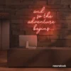 And So The Adventure Begins neon sign in peachy pink for wedding decor, new beginnings, and celebration walls.