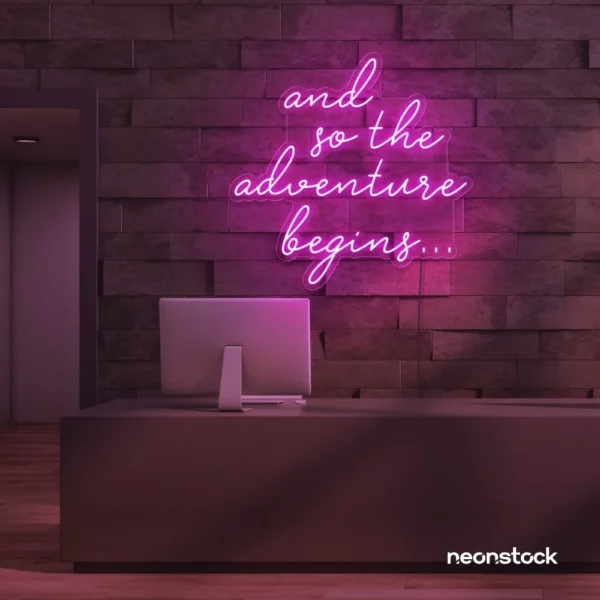 And So The Adventure Begins neon sign in pink for wedding decor, new beginnings, and celebration walls.