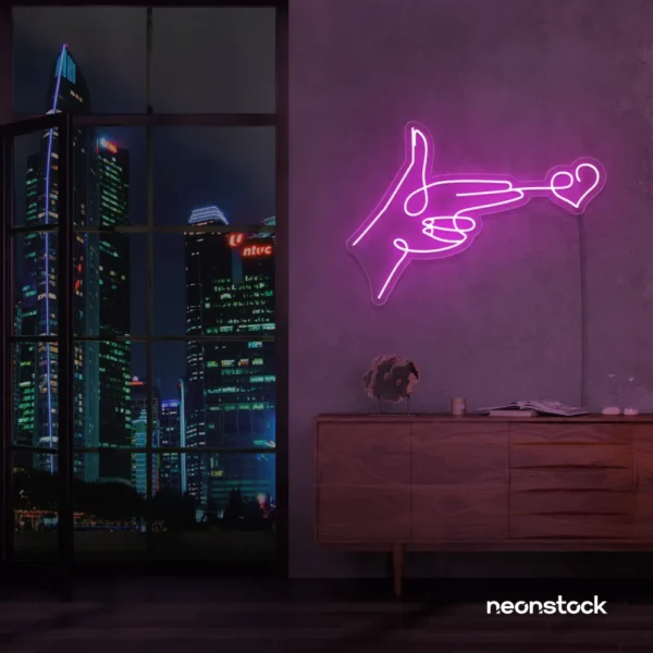 Hands shooting heart neon sign in pink – romantic LED wall decor.