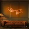 Hands neon sign in orange – modern wall art symbolizing connection and emotion.