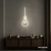 Hanging bulb neon sign in neutral white for cafes, offices, and creative spaces.
