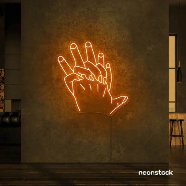 Holding hands neon sign in orange – emotional LED wall decor.
