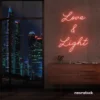 Love and Light neon sign in peachy pink for weddings, romantic decor, and celebration backdrops.