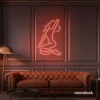 Sitting woman neon sign in peachy pink for minimalist wall art and feminine home decor.