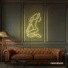 Sitting woman neon sign in warm white for minimalist wall art and feminine home decor.