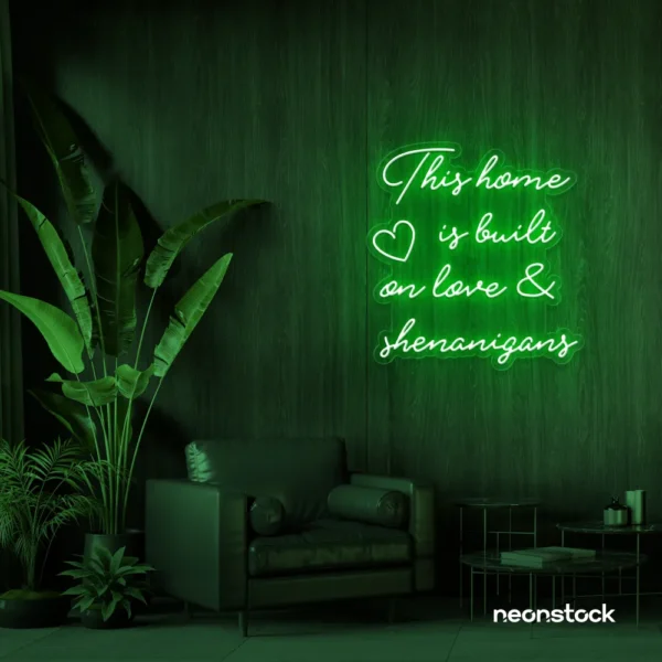 This Home Is Built on Love and Shenanigans neon sign in deep green for family walls, living rooms, and cozy decor.