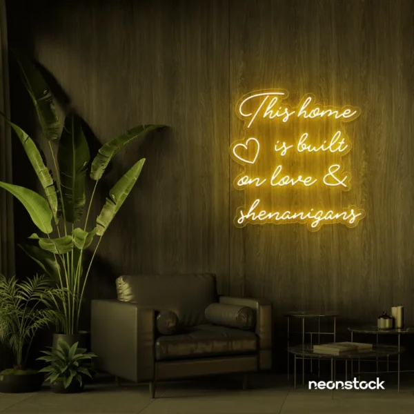 This Home Is Built on Love and Shenanigans neon sign in golden yellow for family walls, living rooms, and cozy decor.