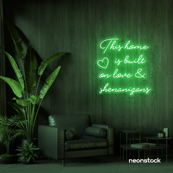 This Home Is Built on Love and Shenanigans neon sign in green for family walls, living rooms, and cozy decor.