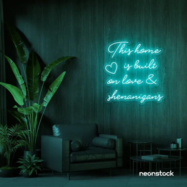 This Home Is Built on Love and Shenanigans neon sign in mint green for family walls, living rooms, and cozy decor.