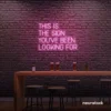 This Is The Sign You’ve Been Looking For neon sign in baby pink for modern wall decor and motivational rooms.
