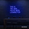 This Is The Sign You’ve Been Looking For neon sign in dark blue for modern wall decor and motivational rooms.