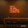 This Is The Sign You’ve Been Looking For neon sign in orange for modern wall decor and motivational rooms.