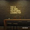 This Is The Sign You’ve Been Looking For neon sign in warm white for modern wall decor and motivational rooms.