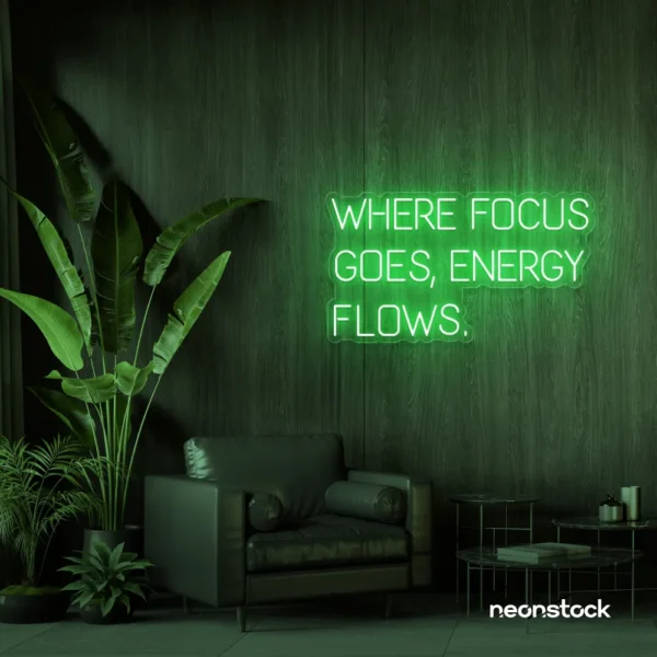 Where Focus Goes Energy Flows neon sign in green for productivity decor and creative inspiration.
