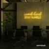 Work Hard Stay Humble neon sign in golden yellow for success-driven decor, workspaces, and personal growth rooms.