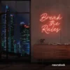Break the Rules neon sign in peachy pink for rebellious decor, creative studios, and bold interiors.