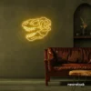 Dinosaur skull neon sign in golden yellow for prehistoric wall art and edgy decor.