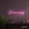 Dreaming neon sign in baby pink for dreamy decor, teen bedrooms, and relaxing nooks.