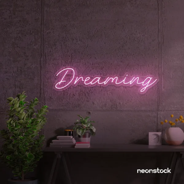 Dreaming neon sign in baby pink for dreamy decor, teen bedrooms, and relaxing nooks.