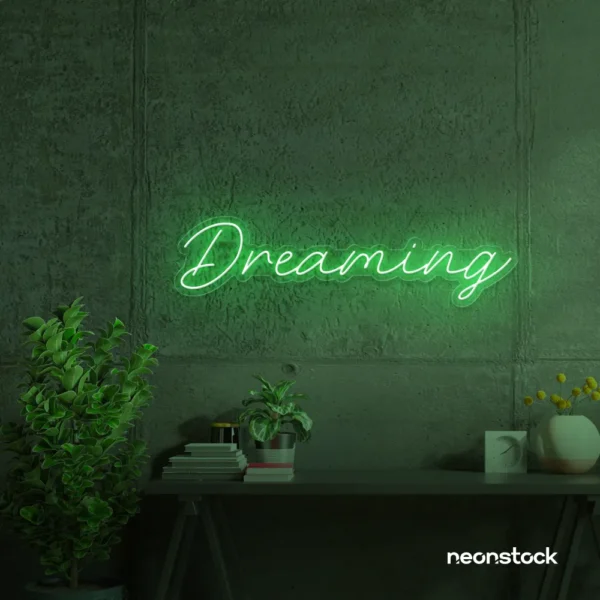 Dreaming neon sign in green for dreamy decor, teen bedrooms, and relaxing nooks.