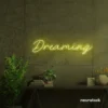 Dreaming neon sign in lemon yellow for dreamy decor, teen bedrooms, and relaxing nooks.