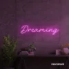 Dreaming neon sign in pink for dreamy decor, teen bedrooms, and relaxing nooks.