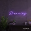 Dreaming neon sign in purple for dreamy decor, teen bedrooms, and relaxing nooks.