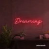 Dreaming neon sign in red for dreamy decor, teen bedrooms, and relaxing nooks.
