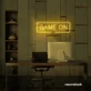 Game On neon sign in golden yellow for gaming setups, man caves, and kids' rooms.