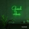 Good Vibes neon sign in deep green for positive room decor, dorm walls, and relaxing interiors.