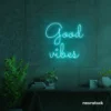 Good Vibes neon sign in mint green for positive room decor, dorm walls, and relaxing interiors.