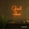 Good Vibes neon sign in orange for positive room decor, dorm walls, and relaxing interiors.