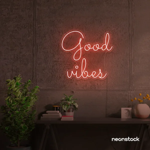 Good Vibes neon sign in peachy pink for positive room decor, dorm walls, and relaxing interiors.