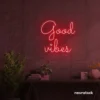 Good Vibes neon sign in red for positive room decor, dorm walls, and relaxing interiors.