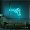 Gun neon sign in mint green – edgy LED wall decor for modern spaces and game rooms.
