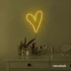 Heart neon sign in golden yellow for beauty salons, home decor, dorm rooms, and Valentine's Day themes.