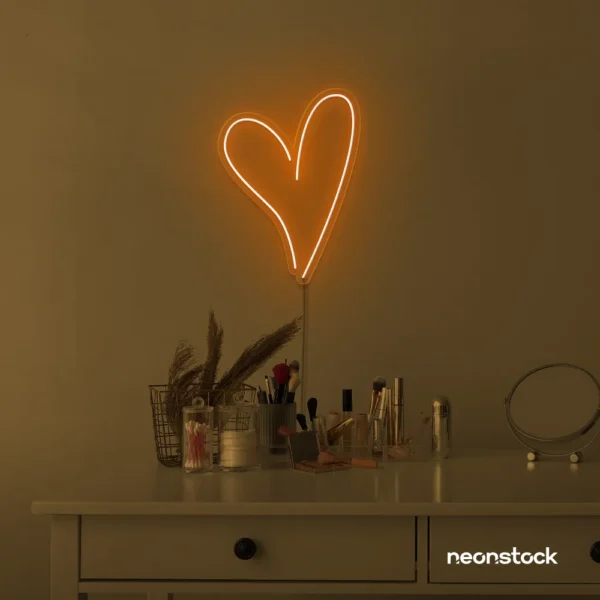 Heart neon sign in orange for beauty salons, home decor, dorm rooms, and Valentine's Day themes.