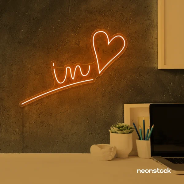 'In Love' neon sign in orange for wedding and Valentine's Day decor