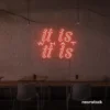 It Is What It Is neon sign in peachy pink for calm decor, chill rooms, and positive interiors.