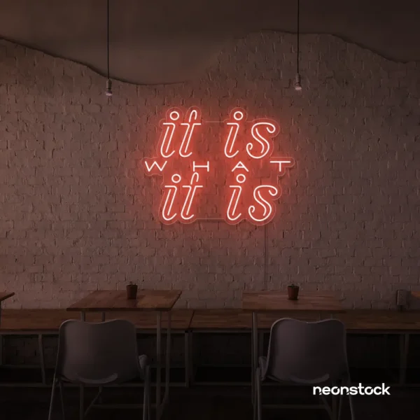 It Is What It Is neon sign in peachy pink for calm decor, chill rooms, and positive interiors.
