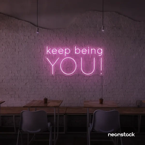 Keep Being You neon sign in baby pink for empowerment decor, teen rooms, and creative wall spaces.