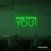Keep Being You neon sign in deep green for empowerment decor, teen rooms, and creative wall spaces.