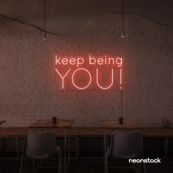 Keep Being You neon sign in peachy pink for empowerment decor, teen rooms, and creative wall spaces.
