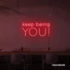 Keep Being You neon sign in red for empowerment decor, teen rooms, and creative wall spaces.